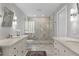 Elegant bathroom with dual vanities, a walk-in shower, and stylish fixtures at 2817 Seabreeze S Dr, Gulfport, FL 33707