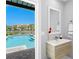 Bathroom with modern vanity and pool views from the window at 2817 Seabreeze S Dr, Gulfport, FL 33707