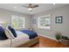 Cozy bedroom with hardwood floors, natural light, and a comfortable rattan chair at 2817 Seabreeze S Dr, Gulfport, FL 33707