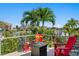 Beautiful home's deck with bright chairs, view of the waterway and tropical landscaping at 2817 Seabreeze S Dr, Gulfport, FL 33707