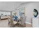 Bright dining room with modern lighting, art, and table seating for four at 2817 Seabreeze S Dr, Gulfport, FL 33707