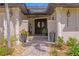 Elegant front entrance with a double door, decorative columns, and brick paved walkway at 2817 Seabreeze S Dr, Gulfport, FL 33707