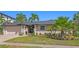 Charming single-story home featuring lush landscaping and a well-manicured lawn at 2817 Seabreeze S Dr, Gulfport, FL 33707