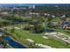 Aerial view of the meticulously maintained greens at Pasadena Yacht & Country Club, surrounded by ponds and mature trees at 2817 Seabreeze S Dr, Gulfport, FL 33707