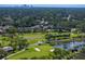 Scenic aerial view of the lush Pasadena Yacht & Country Club golf course with a lake and distant city skyline at 2817 Seabreeze S Dr, Gulfport, FL 33707