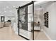 Modern hallway with sliding door, stylish decor, and living room view at 2817 Seabreeze S Dr, Gulfport, FL 33707
