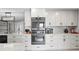 Bright kitchen with sleek, stainless steel appliances, modern countertops, and white cabinetry at 2817 Seabreeze S Dr, Gulfport, FL 33707