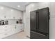 Modern kitchen featuring sleek white cabinetry, stainless steel appliances, and stylish tile backsplash at 2817 Seabreeze S Dr, Gulfport, FL 33707
