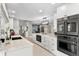 Spacious kitchen featuring modern appliances, a large marble island, and stylish cabinetry at 2817 Seabreeze S Dr, Gulfport, FL 33707