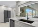 Contemporary kitchen with granite countertops, modern appliances, and a view of the outdoor area at 2817 Seabreeze S Dr, Gulfport, FL 33707