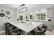 Bright kitchen featuring a large island with seating, modern lighting, and stainless-steel appliances at 2817 Seabreeze S Dr, Gulfport, FL 33707