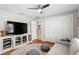 Comfortable living room featuring a large TV, a white couch, and wood floors at 2817 Seabreeze S Dr, Gulfport, FL 33707