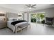 Bright main bedroom featuring a ceiling fan, a bench and a patio that leads to an outdoor living area at 2817 Seabreeze S Dr, Gulfport, FL 33707