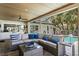 An open-air lounge space with a sectional couch and outdoor kitchen at 2817 Seabreeze S Dr, Gulfport, FL 33707