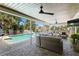 A covered patio with an outdoor seating area and a view of the waterfront pool at 2817 Seabreeze S Dr, Gulfport, FL 33707