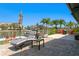 Outdoor patio with luxury lounge chair, outdoor chairs, and tropical landscaping on a sunny day at 2817 Seabreeze S Dr, Gulfport, FL 33707