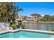 Pool with tropical landscaping and a view of waterfront homes at 2817 Seabreeze S Dr, Gulfport, FL 33707