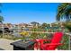 A sunny outdoor area with water views, seating, and tropical plants at 2817 Seabreeze S Dr, Gulfport, FL 33707