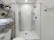 Bright bathroom features a standing shower with built in shelving and tiled accent wall at 2874 Deer Pine Trl, Land O Lakes, FL 34638