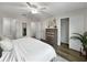 A bright bedroom featuring ceiling fan, wood floors, closet, and ensuite bathroom at 2874 Deer Pine Trl, Land O Lakes, FL 34638