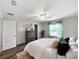 Bright bedroom with wood floors, ceiling fan, and closet at 2874 Deer Pine Trl, Land O Lakes, FL 34638