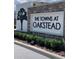 The Towns at Oakstead community entrance sign with stone accents and landscaping at 2874 Deer Pine Trl, Land O Lakes, FL 34638