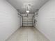 An empty two car garage with white walls and a light tan floor at 2874 Deer Pine Trl, Land O Lakes, FL 34638