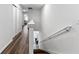 Bright, white hallway with wood-look flooring connects the home's upstairs rooms at 2874 Deer Pine Trl, Land O Lakes, FL 34638