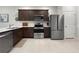 Well-equipped kitchen features stainless steel appliances and stylish dark wood cabinets at 2874 Deer Pine Trl, Land O Lakes, FL 34638
