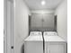 A bright laundry room with closed cabinets above a white washer and dryer set at 2874 Deer Pine Trl, Land O Lakes, FL 34638