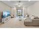 Bright living room featuring tile floors, modern decor, and sliding glass doors to outdoor space at 2874 Deer Pine Trl, Land O Lakes, FL 34638