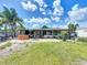 View of the private, fenced-in backyard with covered patio, hot tub, and green space at 2912 Case Ave, Bradenton, FL 34207