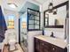 Updated bathroom features blue tiled shower with glass enclosure, and attractive vanity with sink at 2912 Case Ave, Bradenton, FL 34207