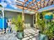 This home features a unique trellis and artistic front yard with potted plants and a sidewalk at 2912 Case Ave, Bradenton, FL 34207