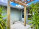 This home features a unique trellis and artistic front yard with potted plants and a sidewalk at 2912 Case Ave, Bradenton, FL 34207