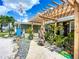 This home features a unique trellis and artistic front yard with rock features and a charming display at 2912 Case Ave, Bradenton, FL 34207