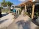 Charming home featuring a pergola-covered entrance, complemented by tropical plants and landscaping at 2912 Case Ave, Bradenton, FL 34207