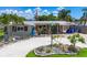Charming home featuring a landscaped front yard, unique rock features, and a covered carport at 2912 Case Ave, Bradenton, FL 34207