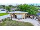 Backyard garage and workshop provides extra storage and workspace, and is surrounded by trees at 2912 Case Ave, Bradenton, FL 34207