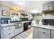 Modern kitchen with stainless steel appliances, granite countertops, and gray cabinetry at 2912 Case Ave, Bradenton, FL 34207
