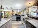 Bright kitchen featuring gray cabinets, stainless steel appliances and butcher block style tile flooring at 2912 Case Ave, Bradenton, FL 34207