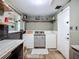 Well-lit laundry area with floating shelves and a door to the outside at 2912 Case Ave, Bradenton, FL 34207