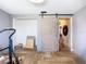 Room with barn style door, wood-look tile, gray walls, and views to the hallway at 2912 Case Ave, Bradenton, FL 34207