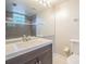 Updated bathroom features a large mirror over a vanity and a toilet at 3002 W Cleveland St # C3, Tampa, FL 33609