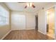 Bedroom featuring wood floors, a closet, a ceiling fan, and a window with blinds at 3002 W Cleveland St # C3, Tampa, FL 33609