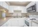 The kitchen features light gray counter tops with white cabinets and appliances at 3002 W Cleveland St # C3, Tampa, FL 33609