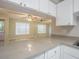 The kitchen has a breakfast bar with gray countertops and white cabinets at 3002 W Cleveland St # C3, Tampa, FL 33609