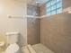 Nicely tiled walk-in shower features glass block window and a shower head with a handle at 3002 W Cleveland St # C3, Tampa, FL 33609