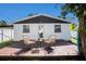 Back of home featuring wood deck with seating, white exterior, and nice yard at 3019 Park N St, St Petersburg, FL 33710