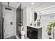 Modern bathroom featuring sleek vanity, unique lighting fixture, and glass enclosed shower with rain shower head at 3019 Park N St, St Petersburg, FL 33710